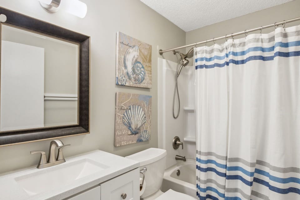 First Floor Full Bathroom Shared by Downstairs Bedrooms with Combination Bathtub/Shower