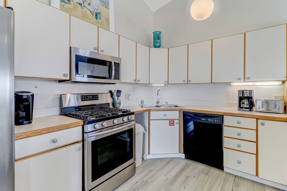 Second Floor Fully Equipped Kitchen with Stainless Steel Appliances and Bar Stool Seating for 5