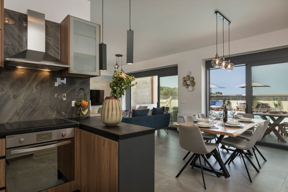 The kitchen, living, and dining areas combine for an open, airy atmosphere.