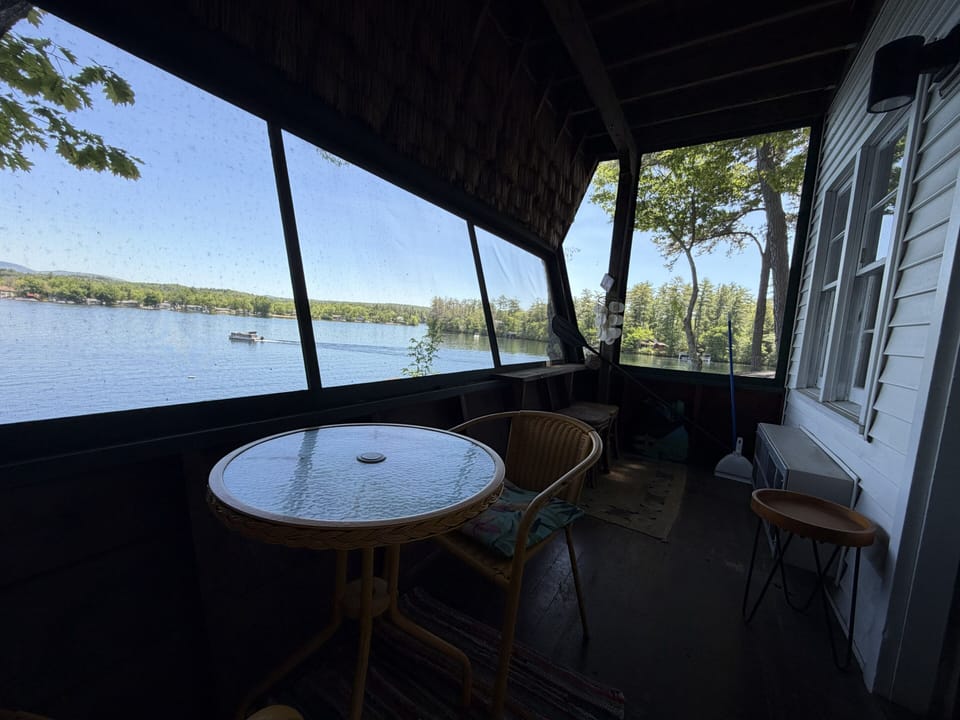 Sip your morning coffee on this screened porch while watching boats drift by and sunlight dance across the lake's peaceful waters.