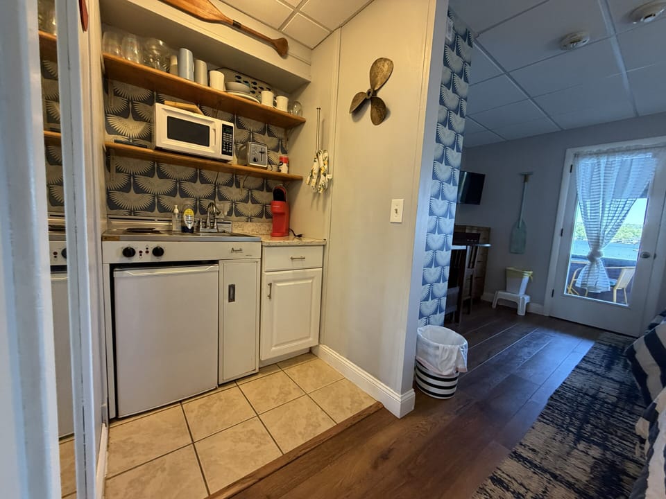 Your cozy kitchenette features a stove, microwave, and charming nautical touches—perfect for preparing light meals while enjoying your lakeside getaway.