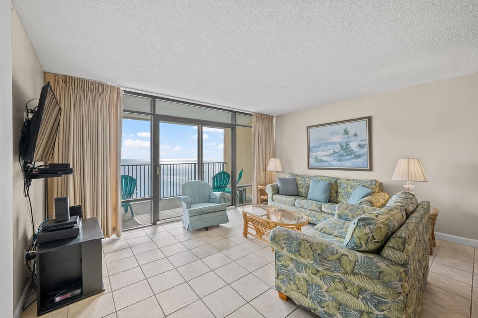 Relax in the comfort of a large well-appointed living room with an ocean view.
