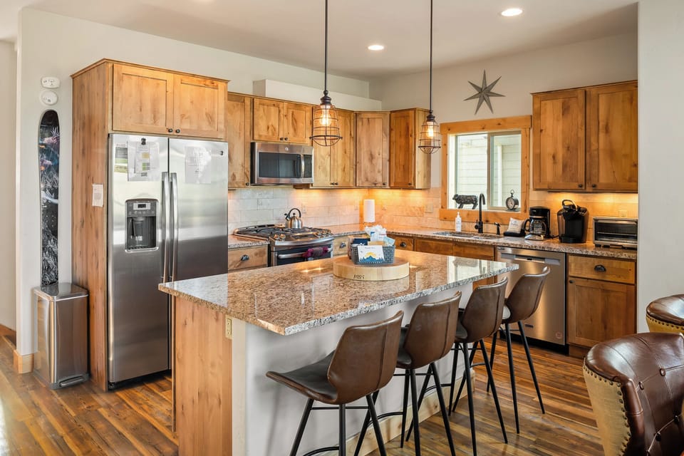 - Modern kitchen with stainless appliances and wood cabinetry   - Granite island and bar seating for group dining   - Fully equipped vacation rental for mountain getaways
