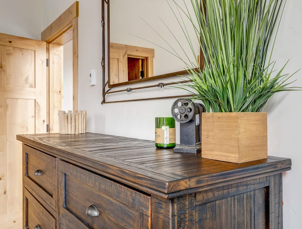 - Bedroom dresser with mirror and decor in rustic cabin style   - Stylish details create inviting Colorado rental atmosphere   - Perfect blend of comfort and design in vacation retreat