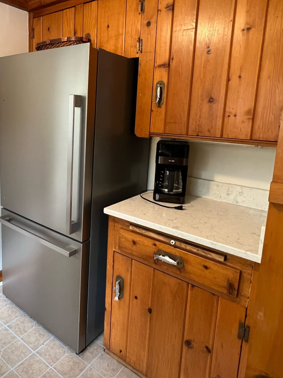 Large, clean refrigerator and coffee bar.