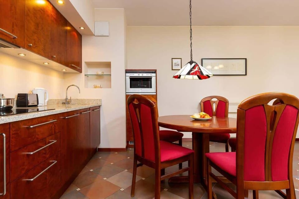 Kitchenette with kettle and refrigerator. 