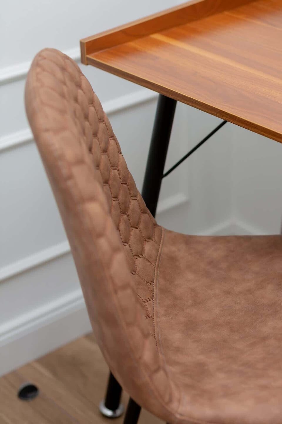 Close-up of a desk with chair, perfect for remote work.