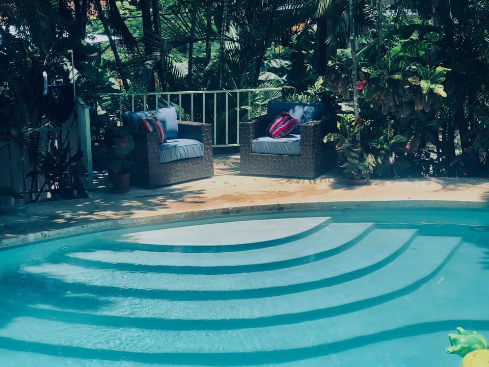 A huge, sparkling pool, with lounge chairs, is shared from Sunrise to Sunset.