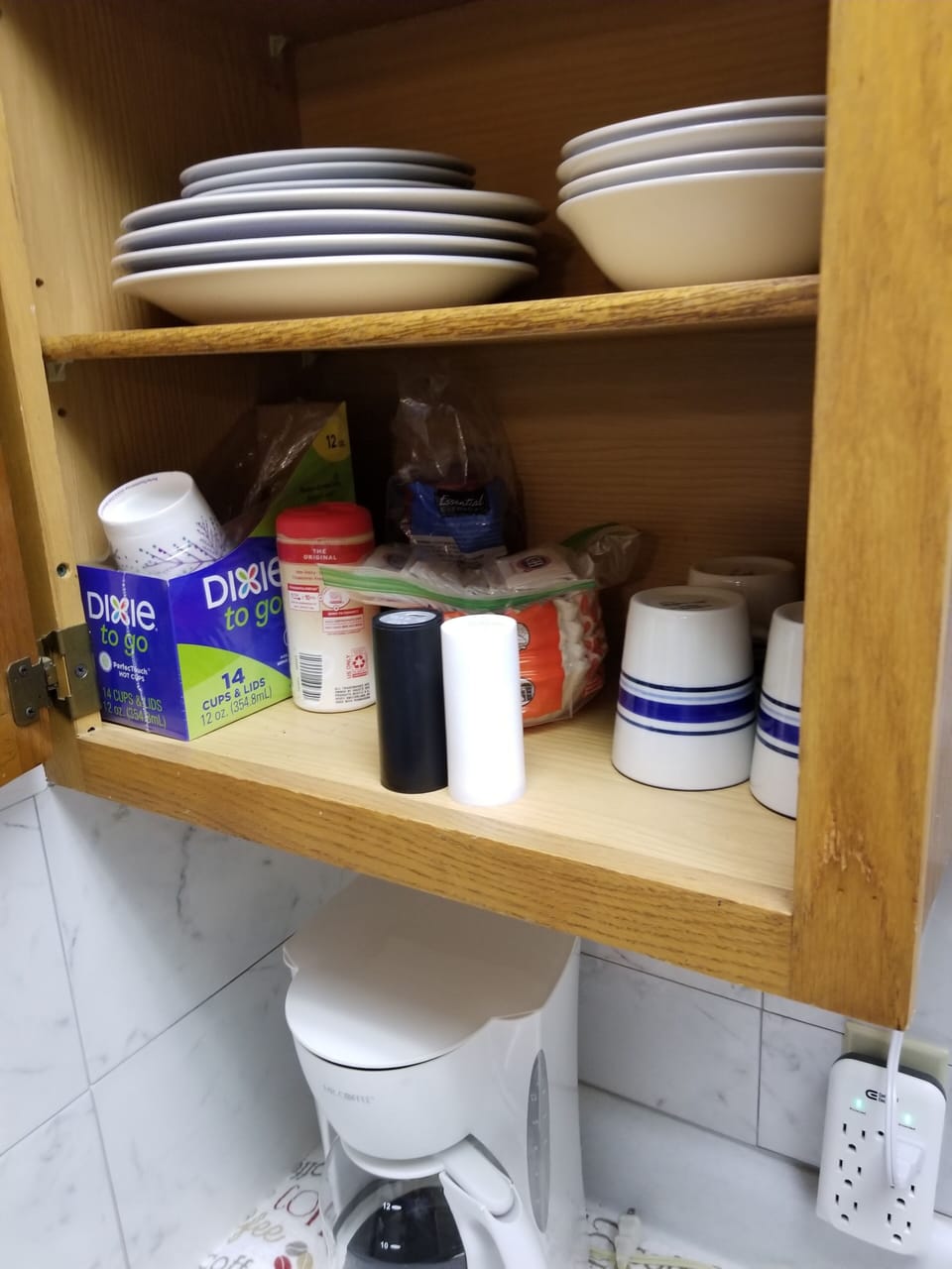 coffee pot with dishes, cups, and some seasonings 