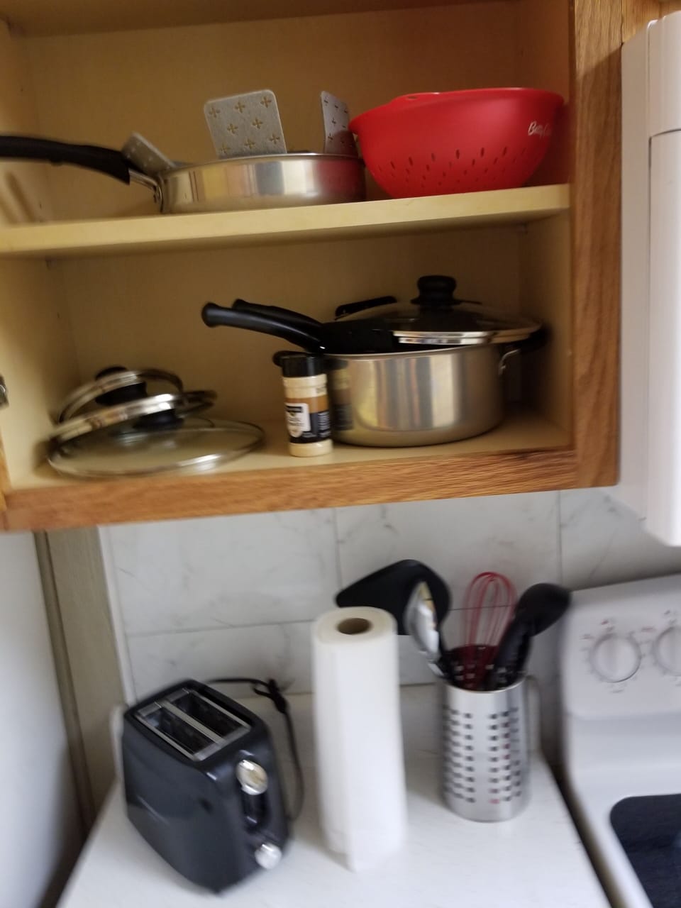 kitchen pots and pans with toaster, some utensils 