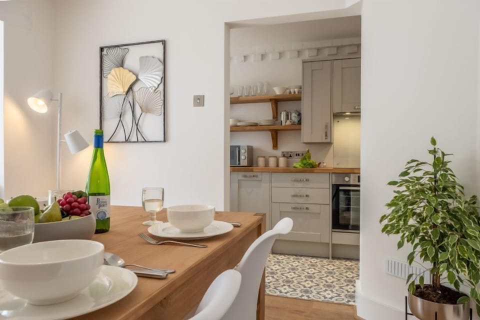 Ground floor: Dining table with kitchen in the background
