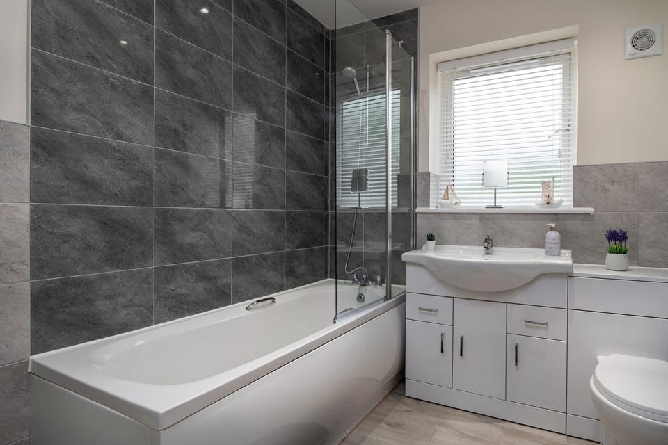 Family bathroom with shower over bath. New combi boiler providing hot water 24/7