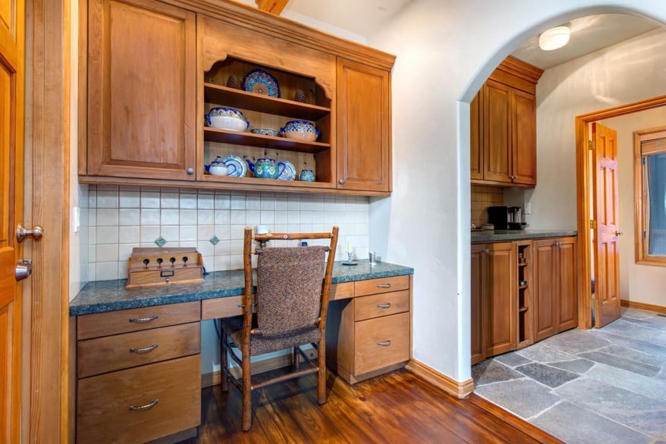 Kitchen includes a built-in desk and pantry, adding workspace and storage.
