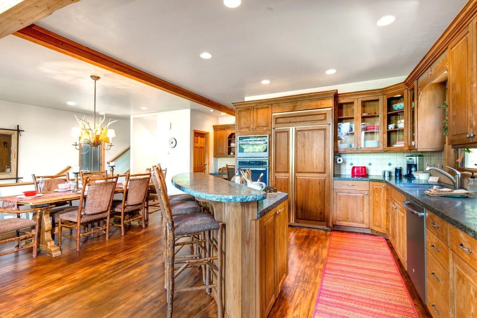 Kitchen layout supports large group meals and easy flow into the dining area.
