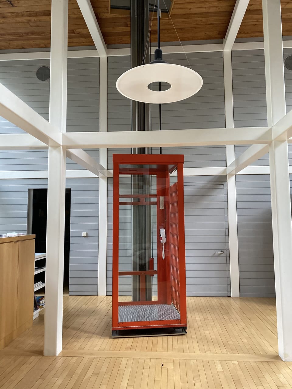 Elevator red as a London telephone booth. The left door leads to a large pantry.