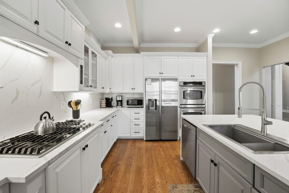 Remodeled kitchen with waterfall island and integrated appliances