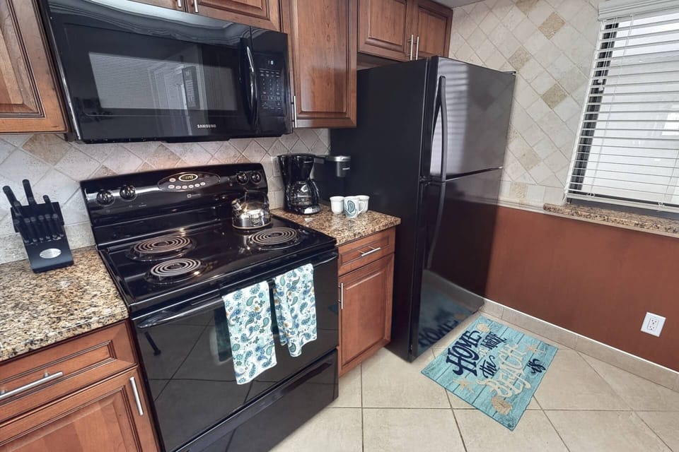 Updated kitchen with solid stone granite counters and stocked with basic essentials.
