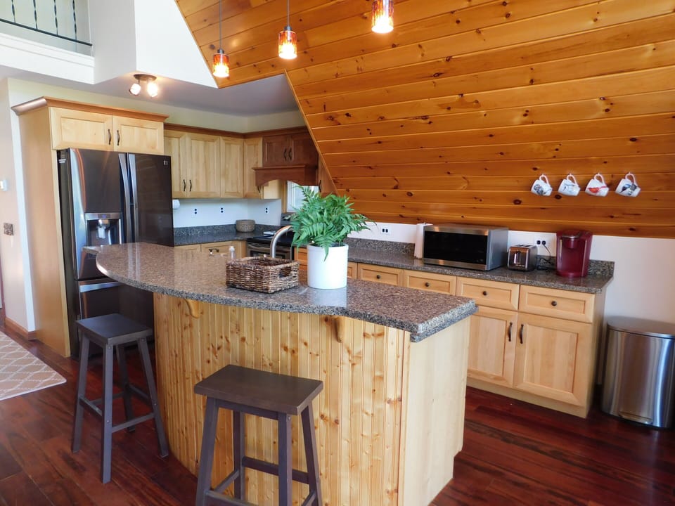 Fully stocked kitchen with warm wood cabinets and granite countertops. 