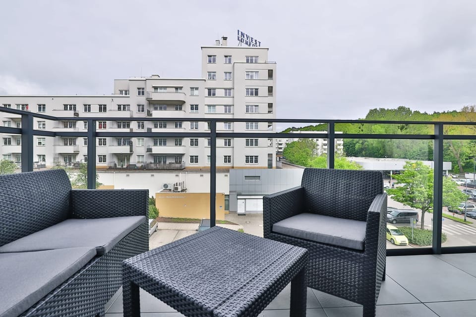 Private balcony with a seating set — perfect for morning coffee or evening wine while enjoying a peaceful city view.