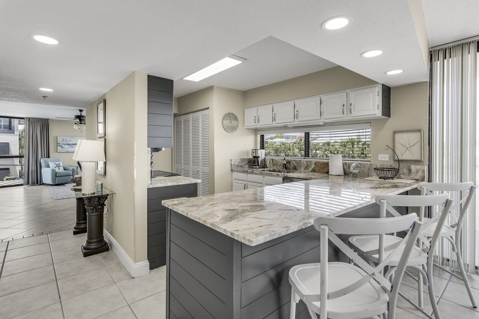 Your gourmet kitchen features marble countertops, modern appliances, and a spacious island perfect for preparing memorable meals during your stay.