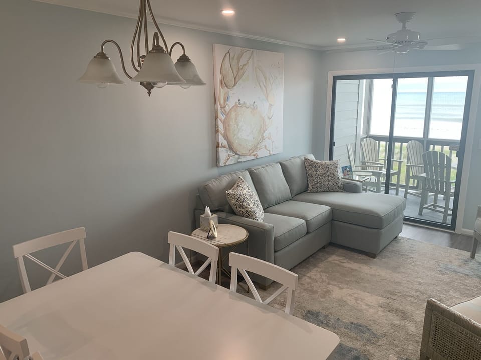 Living room with dining for six plus two additional seats at kitchen counter