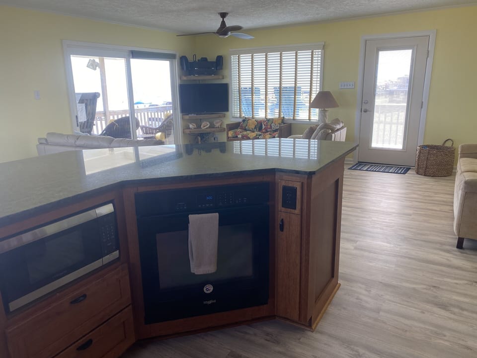 View towards front door and living room from the kitchen.