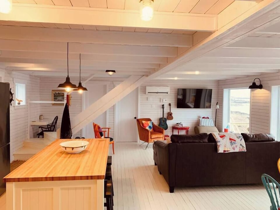The great room seamlessly pulls together kitchen, dining, coffee/bar nook, and work space with a cozy living space. 