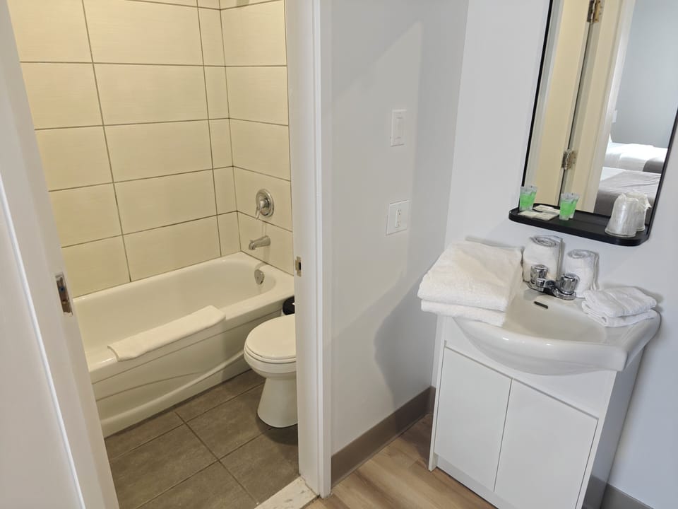 Bathtub, towels, soap, shampoo