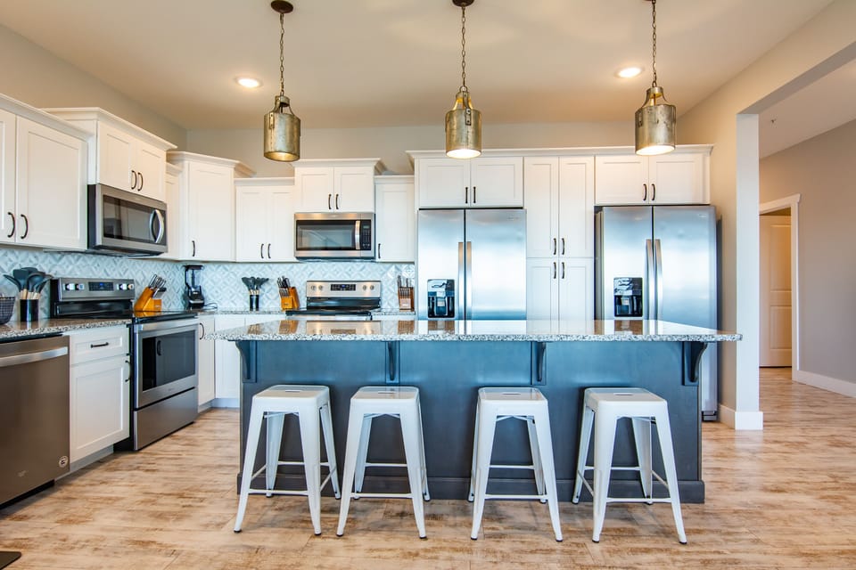 Kitchen with 2 refrigerators, 2 dishwashers, and 2 stoves!