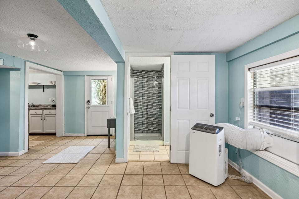The galley kitchen connects to the open studio living space.
