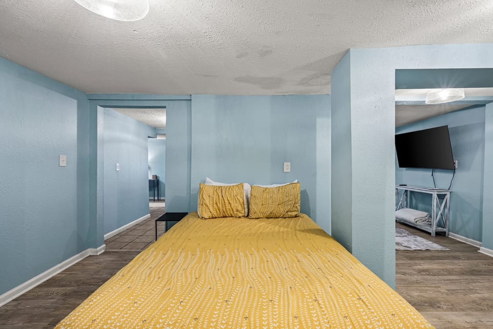 The comfortable sleeping area at Historic Anchor at M, with warm, restful bedding.