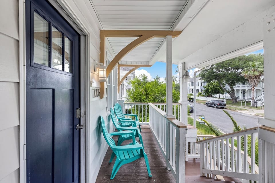 Starboard at M (Upper Right) — a covered porch with teal Adirondack chairs for easy island mornings.