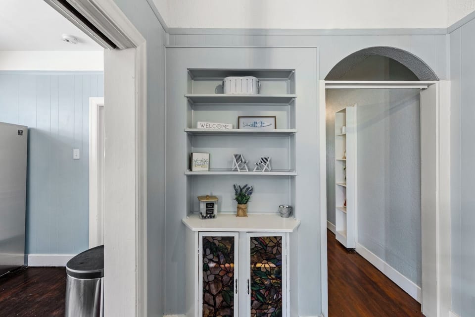 Port Side at M (Upper Left) — a full kitchen with stainless steel appliances and charming built-in storage.