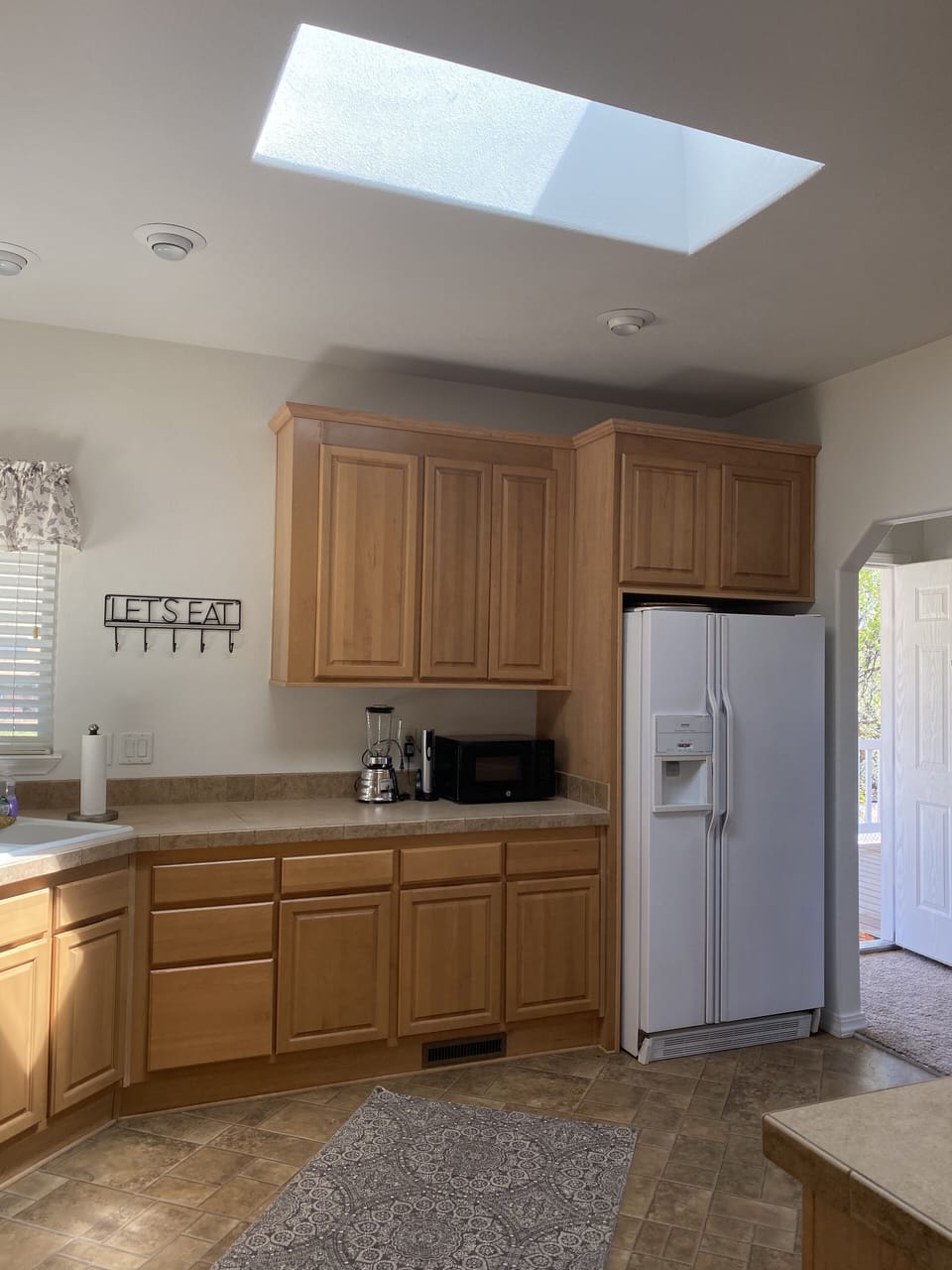 Kitchen, side view, stocked with all the basics