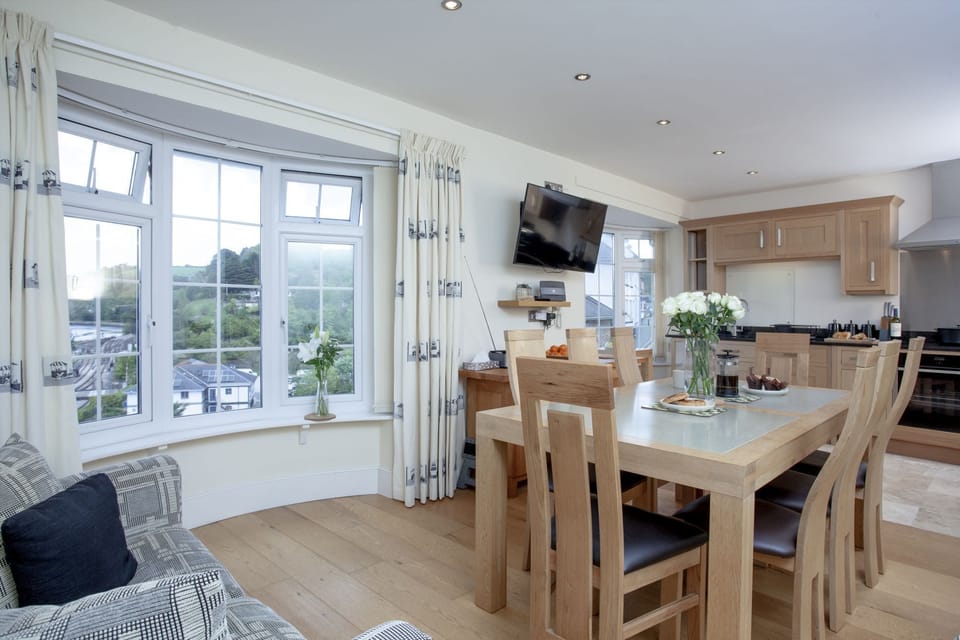 Kitchen and dining area with views over the river and sofa seating - Waterview House