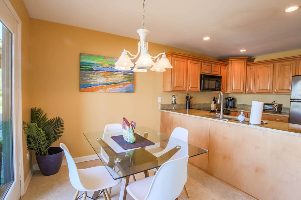 This dining table in the kitchen also seats 4 and has sliding door access to the open patio.