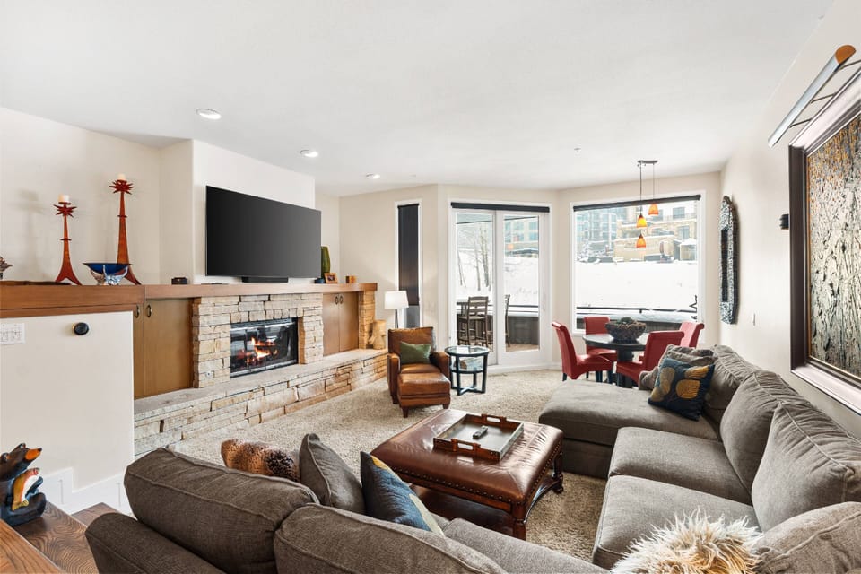 The living room overlooks Assay hill with a gas fireplace, smart tv and sectional sofa