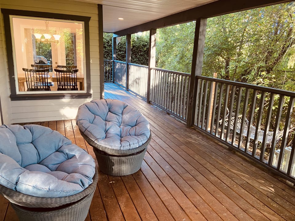 Patio seating overlooking natural acreage bird sanctuary and waterfront