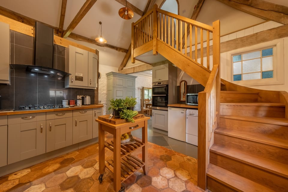 Ground floor: Stairs leading from the kitchen leading up to bedroom two