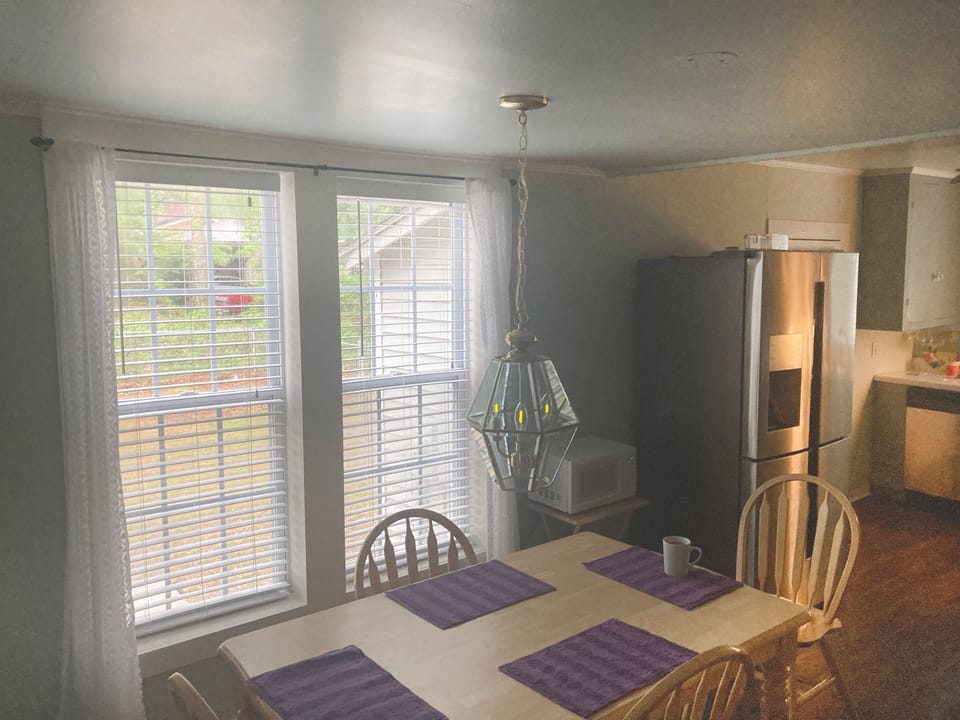 Eat-in-kitchen dinning, side board with coffee maker and waffle iron.  