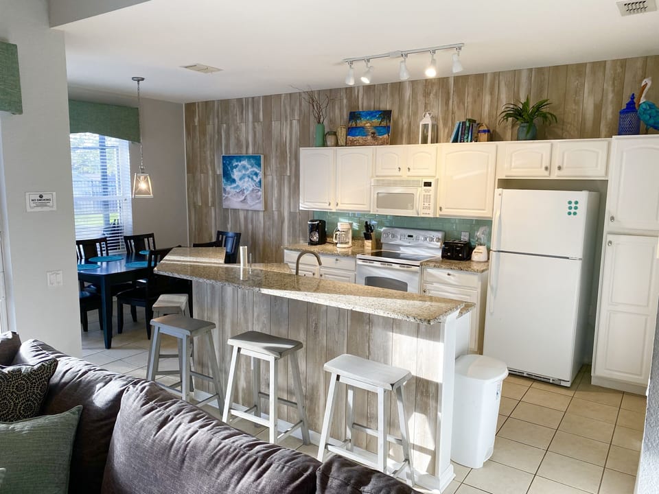 Open kitchen with 4 bar stools and table for 6.