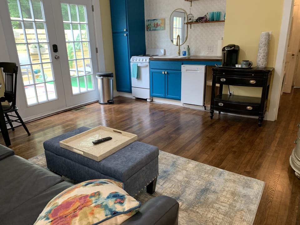 Leather couch and comfy ottoman with view to outdoors and deck