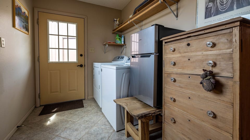 A convenient laundry room with full size washer and dryer on the upper level.