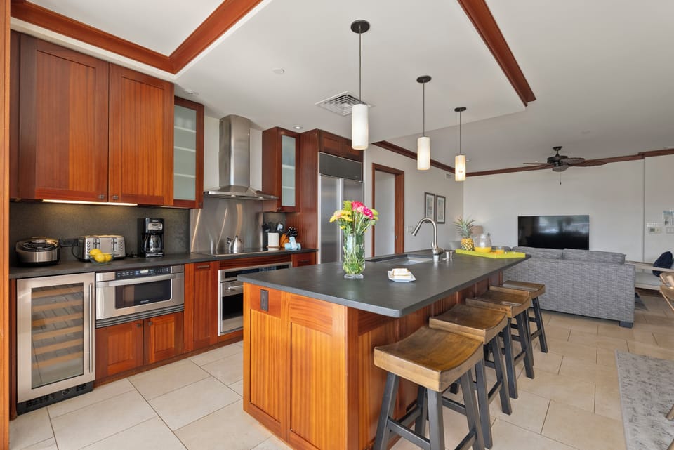 Fully equipped gourmet kitchen with bar seating and an open layout for easy gathering.