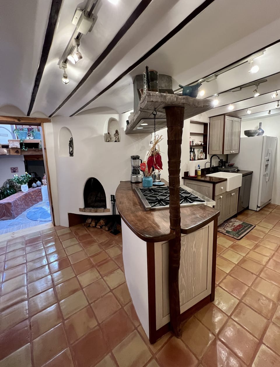 Kitchen with kiva, prep area behind the custom stove peninsula.