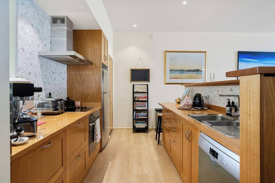 Whip up culinary delights in the kitchen, fully equipped with all the essentials, including a stovetop, oven, and dishwasher, making meal preparation a breeze.

