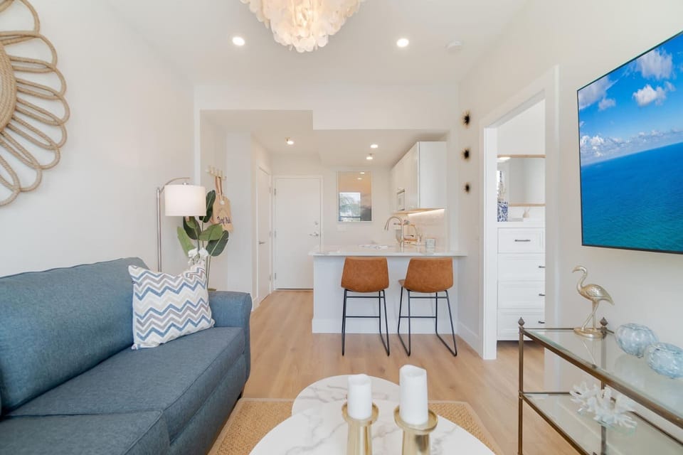 Living Area. Smart flat screen Tv and AC. Fully stocked kitchenette with 2 seater bar counter.
