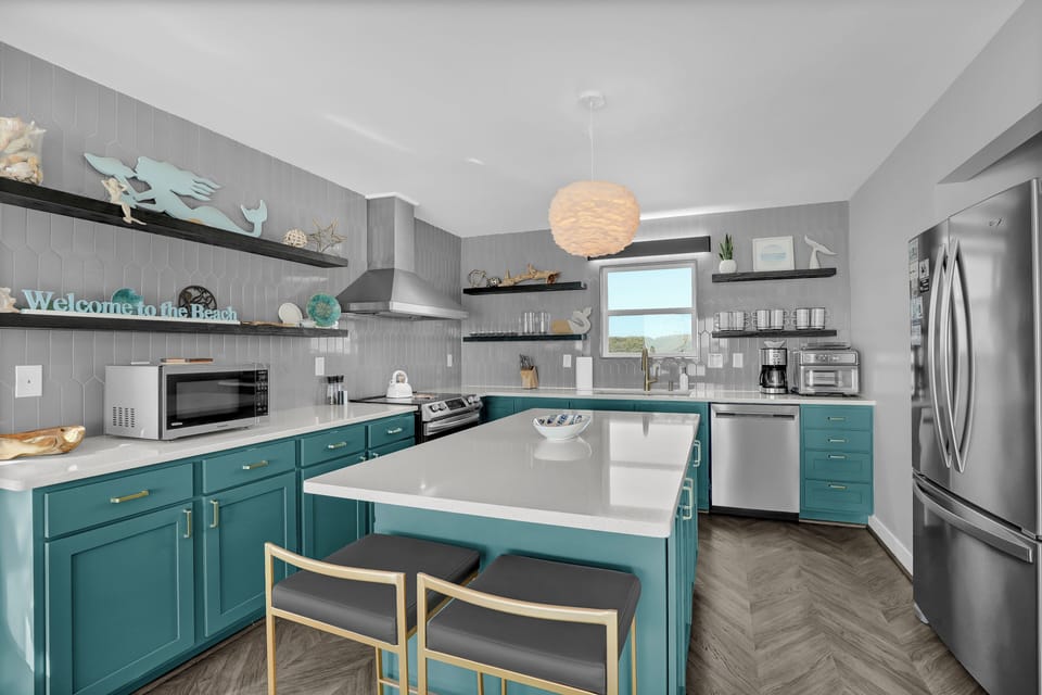 Modern fully stocked gourmet kitchen with bar seating for 2 