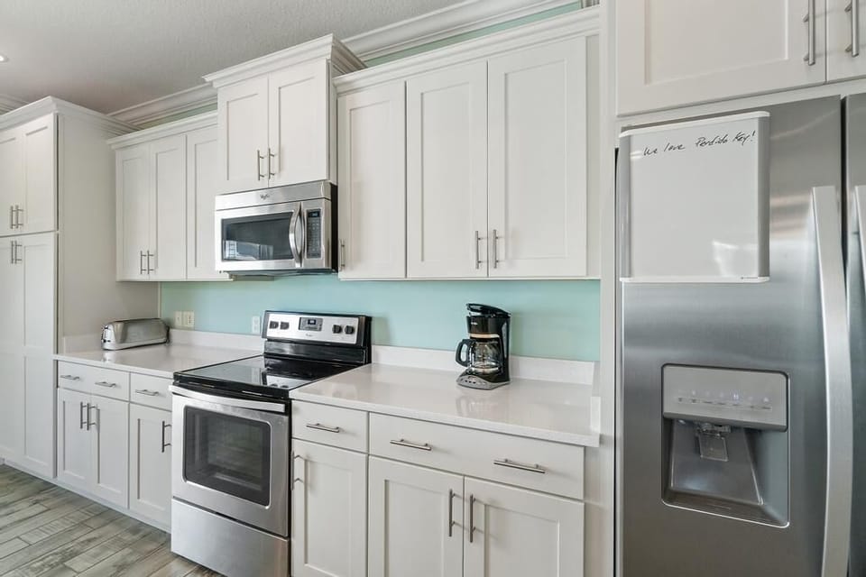 Stunning white quartz counters and stainless steel appliances.