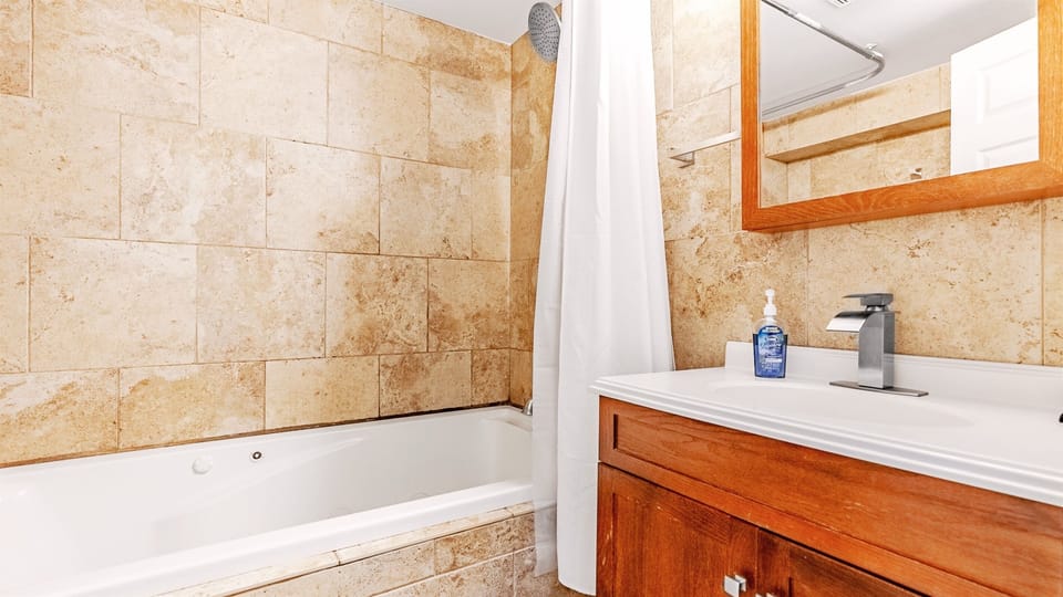The master bathroom has a shower and oversized jetted tub.
